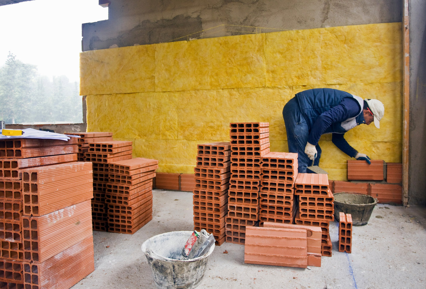 Bricklayer building an internal wall on a construction site